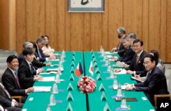 Philippines' President Ferdinand Marcos Jr., left, and Japan's Prime Minister Fumio Kishida, right, are seen at the start of their bilateral meeting at the prime minister's official residence in Tokyo, Dec. 17, 2023.