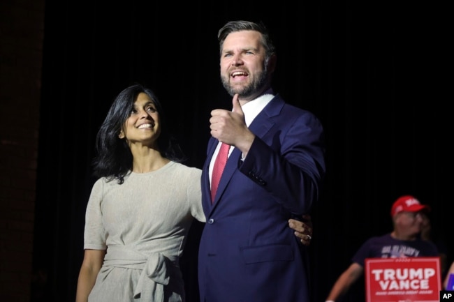 FILE - Republican vice presidential candidate Senator J.D. Vance, right, takes the stage with his wife Usha Vance during a rally in Middletown, Ohio, July 22, 2024. Many Indian Americans, regardless of political leanings, are excited to see Usha Vance in the national spotlight.