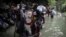 FILE - Haitian migrants wade through water as they cross the Darien Gap from Colombia to Panama in hopes of reaching the U.S., May 9, 2023. 