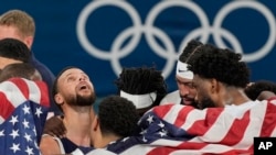 United States' Stephen Curry reacts with his team after winning a men's gold medal basketball game against France at Bercy Arena, Aug. 10, 2024, in Paris.