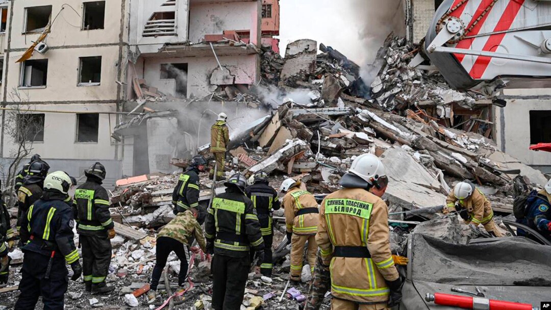 This photo released by Belgorod regional Governor Vyacheslav Gladkov on social media May 12, 2024, shows Russian emergency workers outside a partly collapsed block of flats after a Ukrainian missile attack, in Belgorod city. 