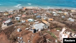 Scattered debris and houses with missing roofs are seen in a drone photograph after Hurricane Beryl passed the island of Petite Martinique, Grenada July 2, 2024.