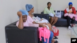 FILE - Women who recently gave birth wait for medical attention at the Nuestra Señora de la Altagracia Maternity Hospital in Santo Domingo, Dominican Republic, Dec. 10, 2023.