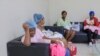 FILE - Women who recently gave birth wait for medical attention at the Nuestra Señora de la Altagracia Maternity Hospital in Santo Domingo, Dominican Republic, Dec. 10, 2023. 