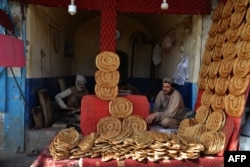Afghan bakers wait for customers at their bakery in Kandahar, March 25, 2024.