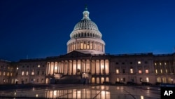 FILE: The U.S. Capitol is illuminated as the Senate worked into the night to finish votes on the debt ceiling and budget cuts package, in Washington, Thursday evening, June 1, 2023. 