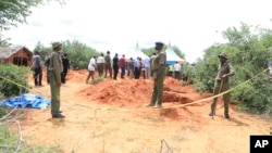 FILE - Police officers are exhuming bodies of victims of a Christian cult that has led to the deaths of hundreds of followers, at a forest near Malindi town, Kenya, April 25, 2023.