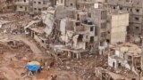 Rescuers and relatives of victims set up tents in front of collapsed buildings in Derna, Libya, Sept. 18, 2023. 