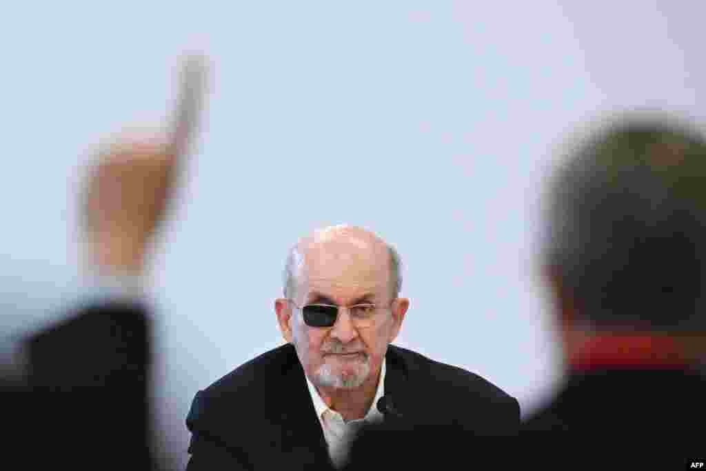 A member of the audience gestures as British-U.S. author Salman Rushdie addresses a press conference at The Frankfurt Book Fair in Frankfurt, Germany.