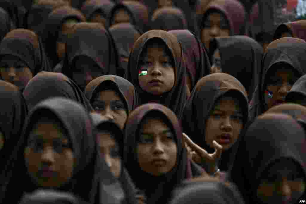 Islamic junior high school students take part in a Quran recitation and make special prayers in support of the Palestinian cause in Banda Aceh, Indonesia.