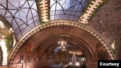 Chandeliers, vaulted tile ceilings and skylights are evident as a train comes through the Old City Hall Station in New York City. (Photo by Patrick Cashin, MTA New York City Transit)