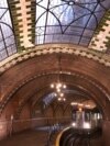 Chandeliers, vaulted tile ceilings and skylights are evident as a train comes through the Old City Hall Station in New York City. (Photo by Patrick Cashin, MTA New York City Transit)