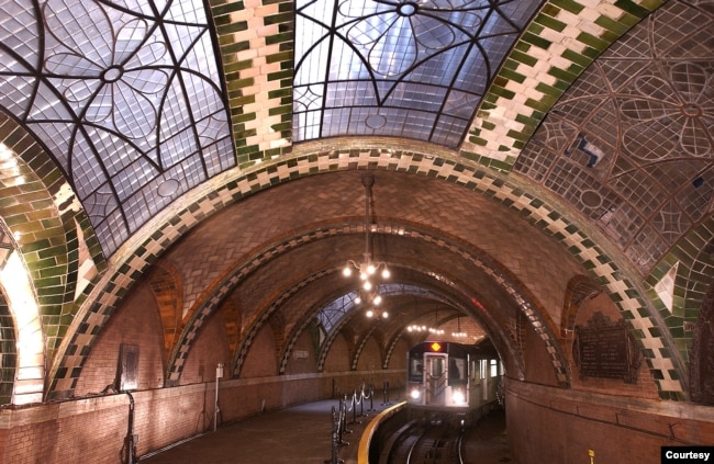 FILE - Chandeliers, vaulted tile ceilings and skylights are evident as a train comes through the City Hall Station in New York City. (Photo by Patrick Cashin, MTA New York City Transit)