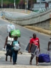 People flee an area where gang violence occurred in Port-au-Prince, Haiti, on April 26, 2024. 