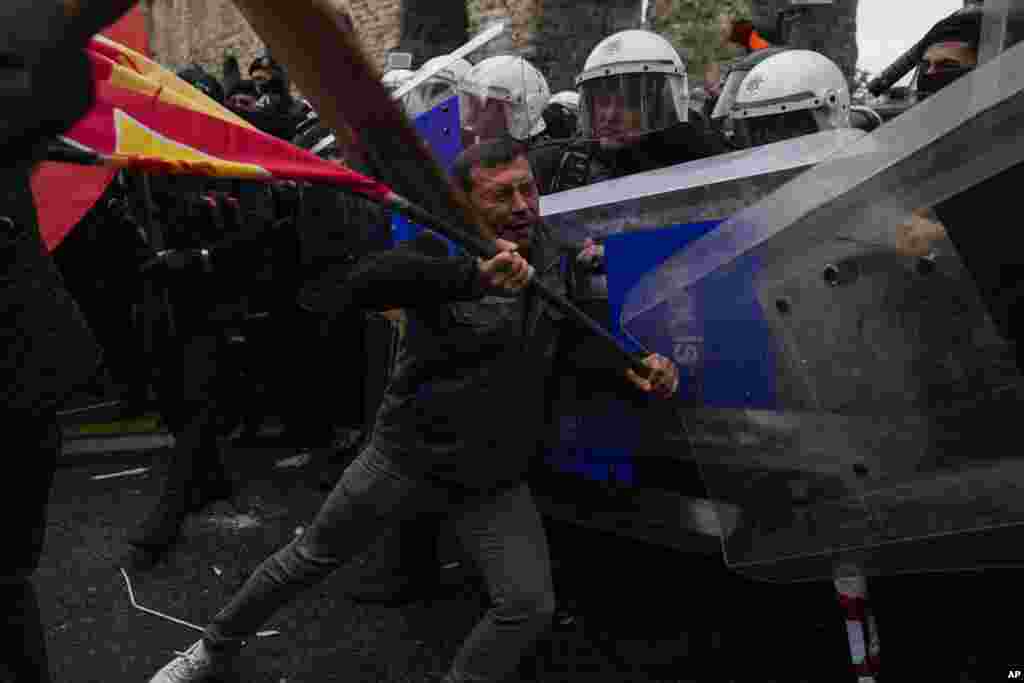 Union members clash with Turkish anti riot police officers as they march during Labor Day celebrations in Istanbul, Turkey.