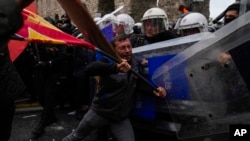 Union members clash with Turkish anti riot police officers as they march during Labor Day celebrations in Istanbul, May 1, 2024.