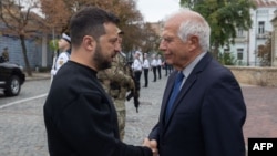 This handout photo released by Ukraine's Presidential Press Service on Oct. 1, 2023, shows Ukraine's President Volodymyr Zelenskyy (L) shaking hands with EU foreign policy chief Josep Borrell during a ceremony marking Defenders Day of Ukraine in Kyiv.