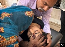 A couple try to pacify their daughter suffering from heat related ailment as she is brought to the government district hospital in Ballia, Uttar Pradesh state, India, Monday, June 19, 2023.