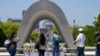 Visitors pray before flowers placed at the Hiroshima Peace Memorial Park, ahead of the Group of Seven nations' meetings in Hiroshima, western Japan, May 17, 2023.