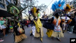 FILE - Members of the Zulu Tramps dance at the Krewe of Zulu parade during Mardi Gras on March 1, 2022, in New Orleans.