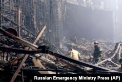 In this photo released by Russian Emergency Ministry Press Service on March 23, 2024, firefighters work in the burned concert hall after an attack on the building of the Crocus City Hall in Moscow, Russia. (Russian Emergency Ministry Press Service via AP)