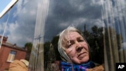 Liudmila, 85, looks though the window of a bus after being evacuated from Vovchansk, Ukraine.&nbsp;Her husband was killed in their house after a Russian airstrike on the city.&nbsp;