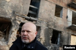 國際刑事法院檢察官卡里姆·汗（Karim Khan）在烏克蘭沃斯霍諾德被俄羅斯導彈襲擊炸毀的民用住宅樓現場。（2023年2月28日）