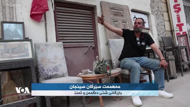 دووکاندارێک لە هاتای تورکیا هانی خەڵک دەدات بگەڕێنەوە باری ئاسایی خۆیان