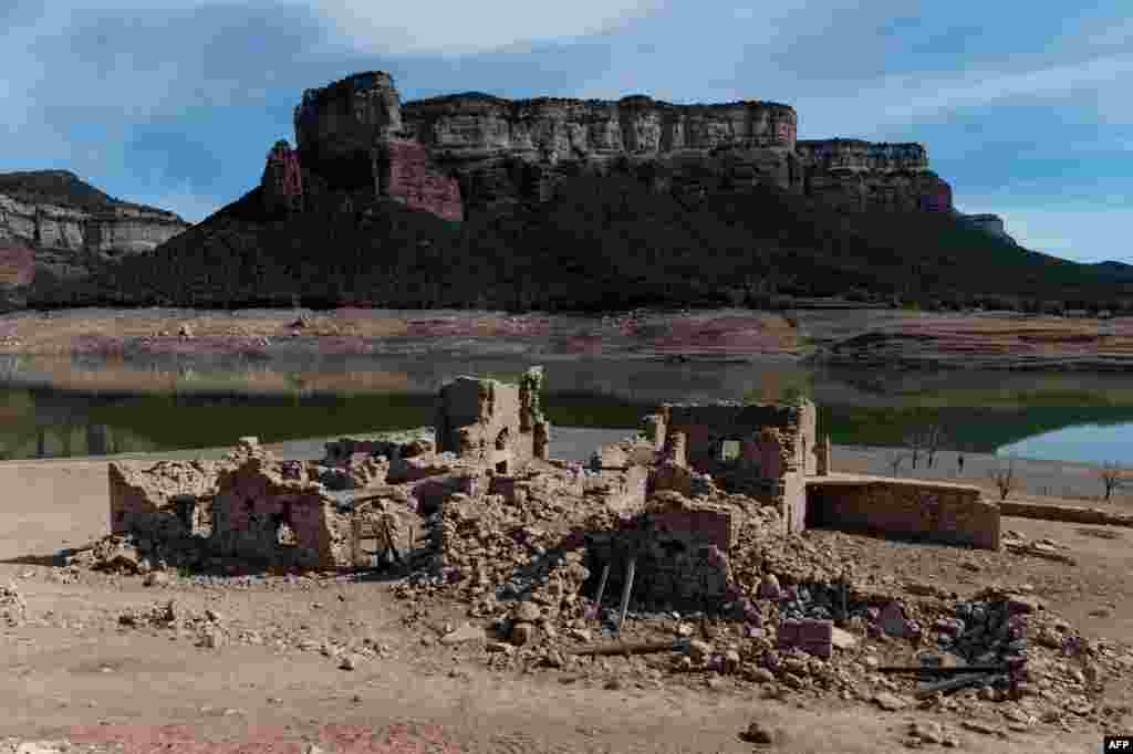 The ruined houses of Sant Roma de Sau are seen on the dried banks of the swamp of Sau, located in the province of Girona in Catalonia, Spain, April 16, 2023.