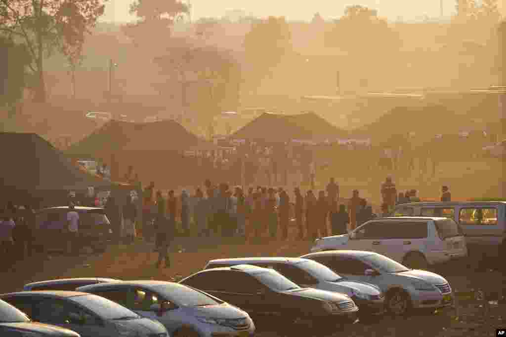 Voters wait in a queue to cast their votes at a polling station in Harare, Wednesday, August 23 2023. Polls opened in Zimbabwe on Wednesday as President Emmerson Mnangagwa seeks a second and final term in a country with a history of violent and disputed votes.