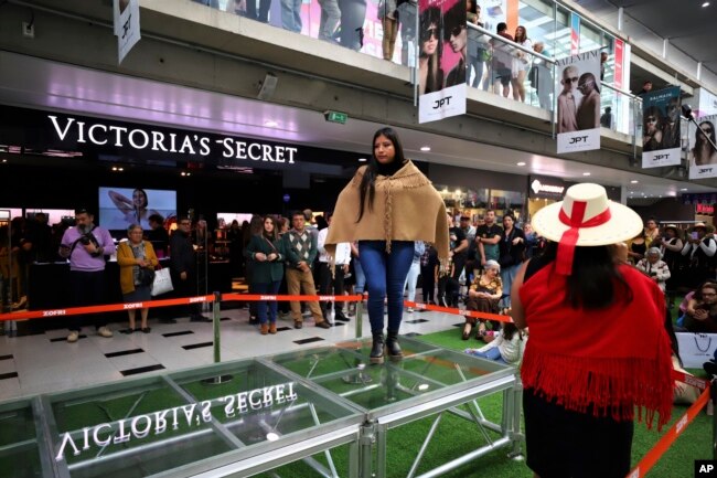 A young Aymara Indigenous woman wears a wool creation weaved by an elder woman from her community, during a fashion show showcasing Indigenous creations at Zofri Mall in Iquique, Chile, Saturday, July 29, 2023. (AP Photo/Ignacio Munoz)