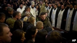 Ukrainian President Volodymyr Zelenskyy attends the funeral of Ukrainian officer Dmytro Kotsiubaylo at St. Michael Cathedral in Kyiv, March 10, 2023. (Ukrainian Presidential Press Office via AP)