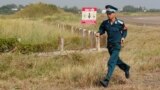 A Vietnamese soldier runs past dioxin contaminated area at the Bien Hoa airbase in Vietnam.