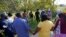 Residents gather for a prayer near the scene of a mass shooting at a Dollar General store in Jacksonville, Florida, Aug. 26, 2023.