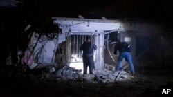 Israeli police check the damage from a rocket fired from the Gaza Strip in Tel Aviv, Israel, Oct. 7, 2023. 