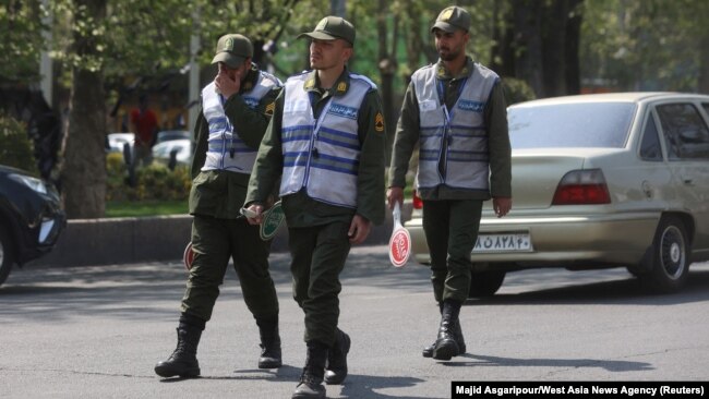 Iran's police forces walk on a street amid the implementation of the new hijab surveillance in Tehran, Iran, April 15, 2023. (Majid Asgaripour/West Asia News Agency via Reuters)