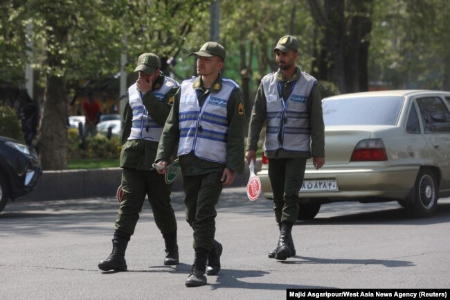 FILE - Members Iran's police force walk on a street amid the implementation of the new hijab surveillance in Tehran, Iran, April 15, 2023. (Majid Asgaripour/WANA via Reuters)
