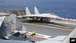 FILE - In this photo released by Xinhua News Agency, a J-15 Chinese fighter jet prepares to take off from an aircraft carrier during military exercises around the Taiwan Island by the Chinese People's Liberation Army, April 9, 2023. 