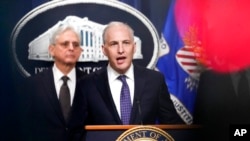 FILE - Justice Department's Assistant Attorney General for the National Security Division Matthew Olsen speaks during a news conference at the Department of Justice in Washington, Jan. 27, 2023, as Attorney General Merrick Garland listens at left. 