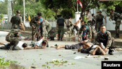 FILE - Thai soldiers apprehend some of hundreds of men after demonstrators clashed with police outside the Tak Bai police station in Thailand's Narathiwat province, some 1150 km south of Bangkok, Oct. 25, 2004.