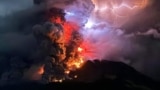 This handout photograph taken and released by the Center for Volcanology and Geological Hazard Mitigation on April 17, 2024, shows Mount Ruang spewing hot lava and smoke as seen from Sitaro, North Sulawesi.