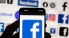 FILE - The Facebook logo is seen on a cell phone, on Oct. 14, 2022. On April 8, 2024, the Committee to Protect Journalists urged the Taliban not to move ahead with its plan to restrict access to Facebook in Afghanistan. 