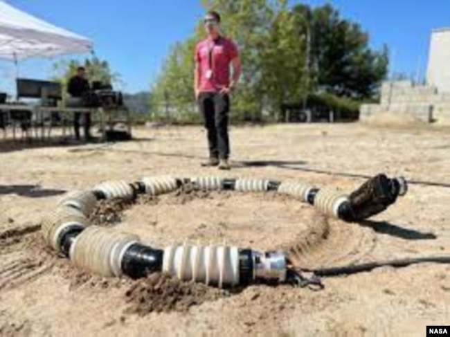 EELS is tested in the sandy terrain of JPL's Mars Yard in April. Engineers repeatedly test the snake-like robot across a variety of terrain, including sand, snow and ice. (Photo Credit: NASA/JPL-Caltech)