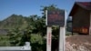 FILE - A sign warning against harboring people who cross the border is displayed near Lingjiang, on the border with North Korea, in northeastern China's Jilin province, Aug. 30, 2017. Beijing has reportedly repatriated hundreds of defectors from North Korea.