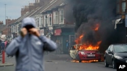 A car burns during an anti-immigration riot in Middlesbrough, England, on Aug. 4, 2024.