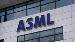 FILE - The logo of ASML hangs on the head office in Veldhoven, Netherlands, Jan. 30, 2023. The Dutch government announced Tuesday it is planning on imposing additional restrictions on the export of machines that make advanced processor chips.