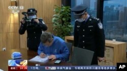 In this image taken from video footage run by China's CCTV, Chinese police conduct law enforcement work during a raid at Capvision offices in Shanghai, May 8, 2023.