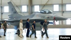 FILE - Ukrainian President Volodymyr Zelenskiy and Dutch Prime Minister Mark Rutte walk past an F-16 fighter jet in Eindhoven, Netherlands, Aug. 20, 2023.