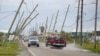 FILE - Power lines bend toward the road after Hurricane Zeta hit Grand Isle, in the U.S. state of Louisiana, Oct. 30, 2020.