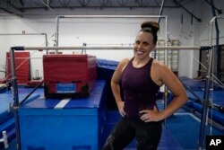 Angela Fuller, 44, takes a break from training to pose at 5280 Gymnastics in Littleton, Colorado, July 24, 2024.